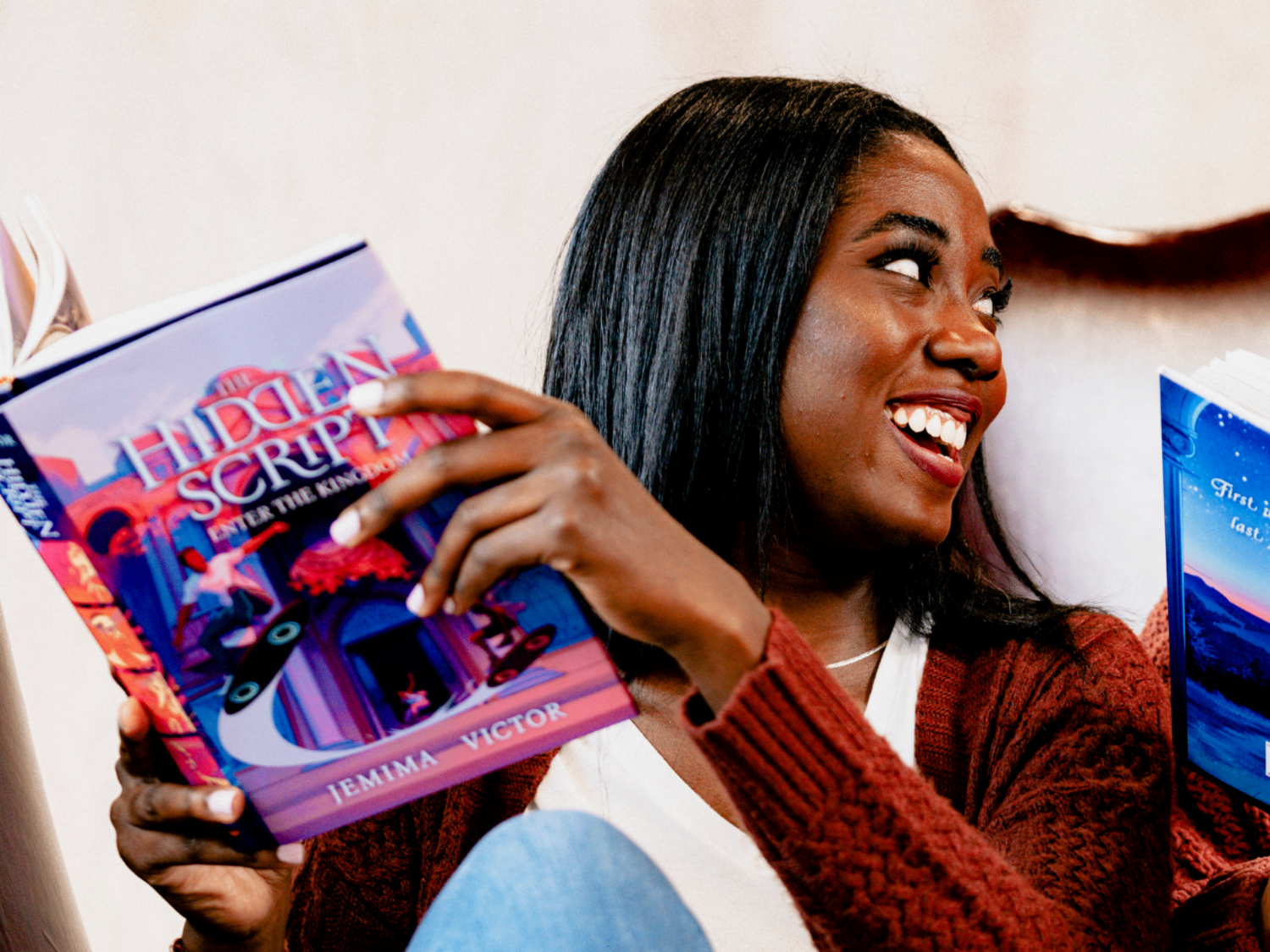Author smiling while reading her finished book