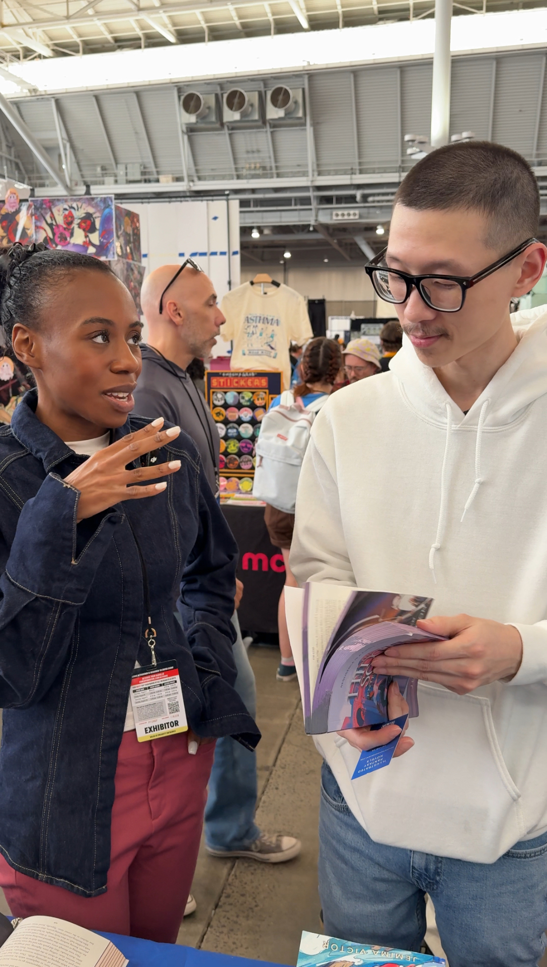Jemima talking with a reader considering The Hidden Script at a convention