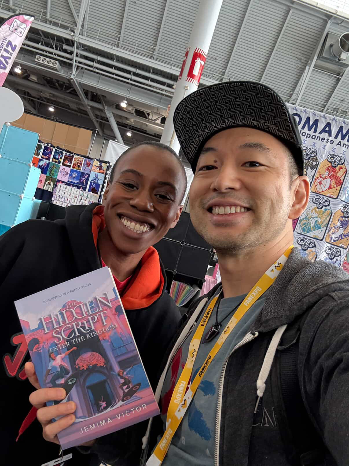 Jemima smiling with a reader holding their purchased copy of The Hidden Script